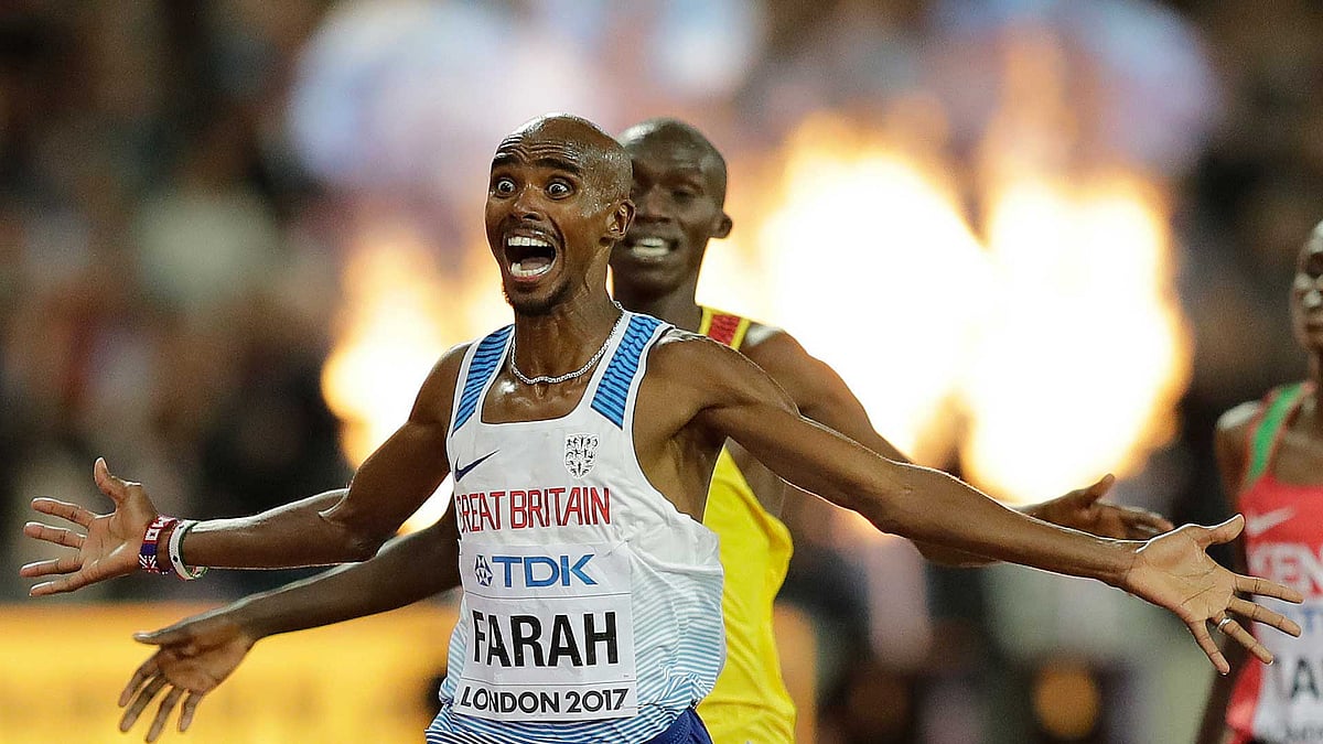Britain’s Mo Farah, left, celebrates after winning the Men’s 10,000 meters final during the World Athletics Championships in London