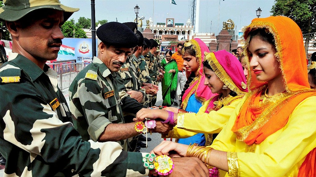 Students tie Rakhis on the wrists of BSF personnel in Amritsar on Monday. 