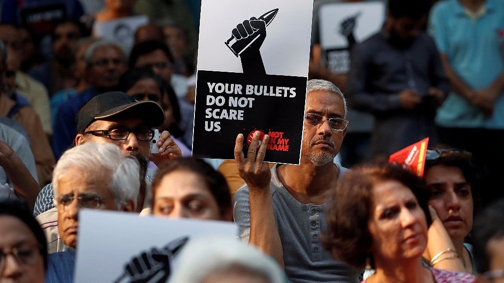 People attend a protest in New Delhi against the killing of Gauri Lankesh.