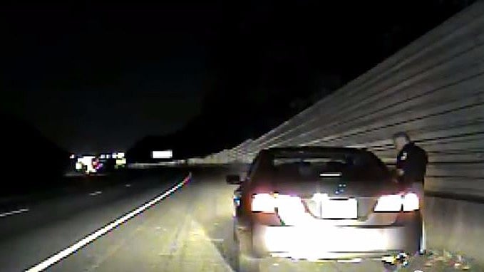 The video shows an interaction between the Cobb County police officer and a woman who said she was afraid to move her hands during a traffic stop.