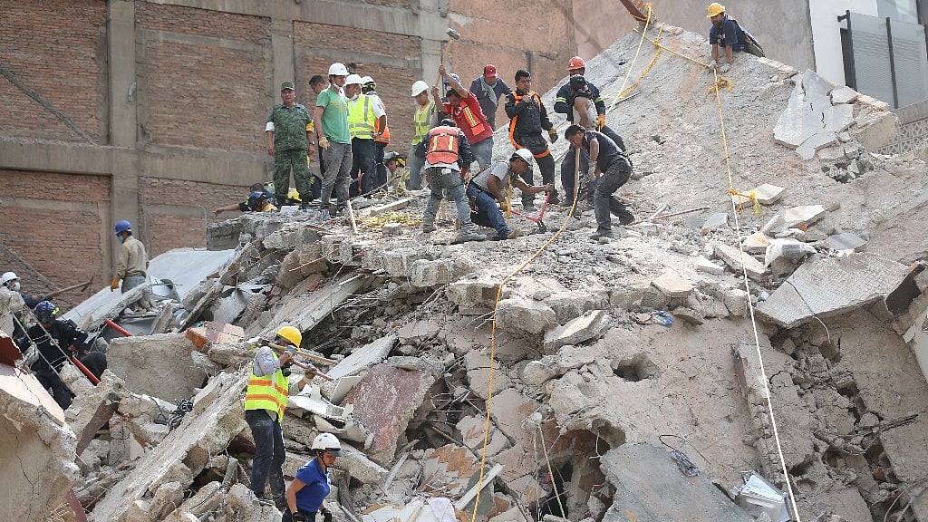 Rescue team look for survivors trapped underneath the rubble.