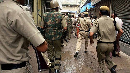 Policemen rush to Batla House during the encounter in New Delhi in September 2008.