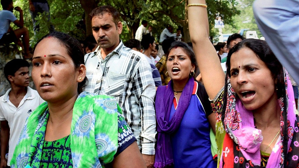 Demonstrators raise slogans during a protest outside Ryan International School as they demand action against the school.