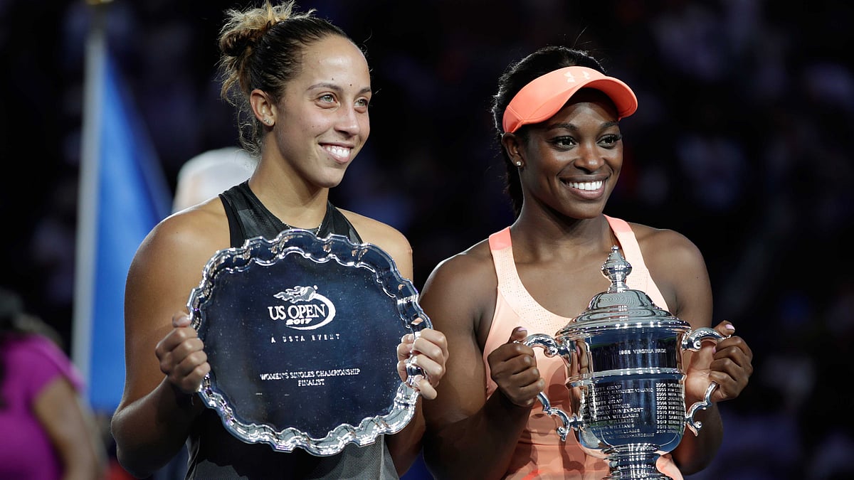 Madison Keys, of the United States, left, holds up the finalist trophy as Sloane Stephens, of the United States, holds the championship trophy after Stephens won the women’s singles final of the U.S. Open