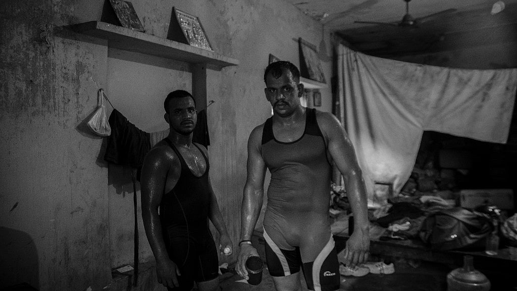 Wrestlers posing for a picture after coming from the field.