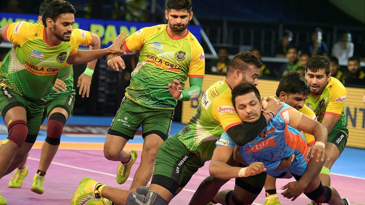 Deepak Narwal of Bengal Warriors being caught by Patna Pirates (Green) during their Pro Kabaddi Qualifier-2 Play offs match at Nehru Indoor Stadium in Chennai.