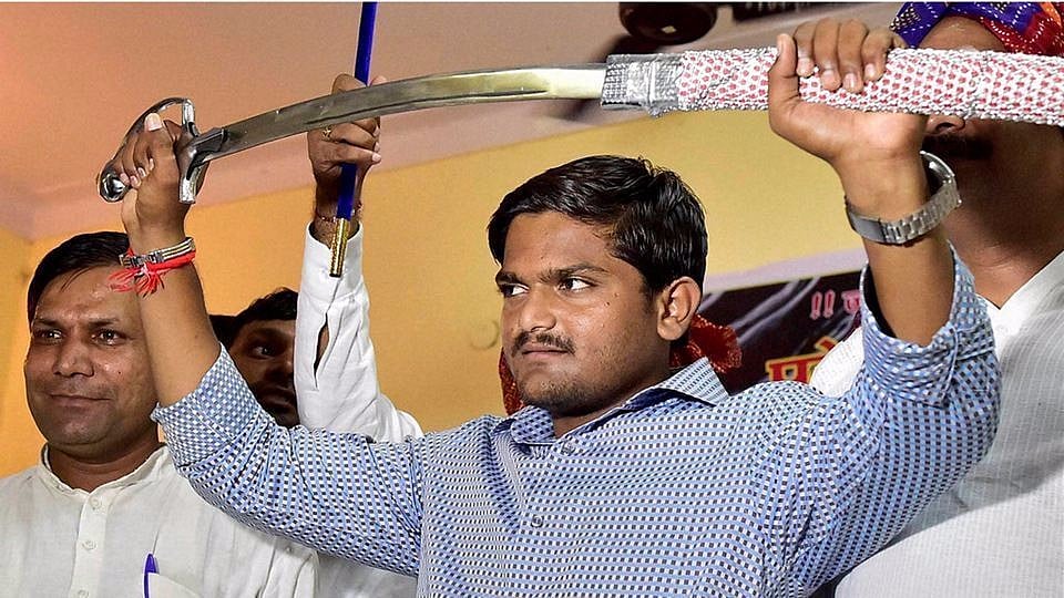 Hardik Patel brandishes a sword presented to him by Gujjars in New Delhi. 