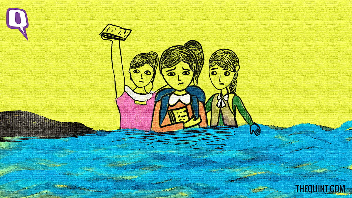 Schoolgirls cross the flooded river 