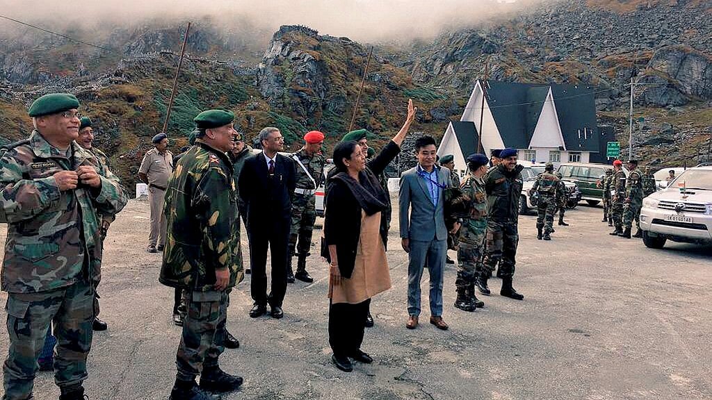 Nirmala Sitharaman waving at Chinese soldiers from across the fence, who were taking pictures on her reaching Nathu La. 