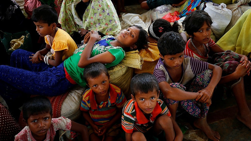 Newly arrived Rohingya refugees sit inside a shelter at the Kutupalang Registered Refugee Camp, in Cox’s Bazar, Bangladesh.