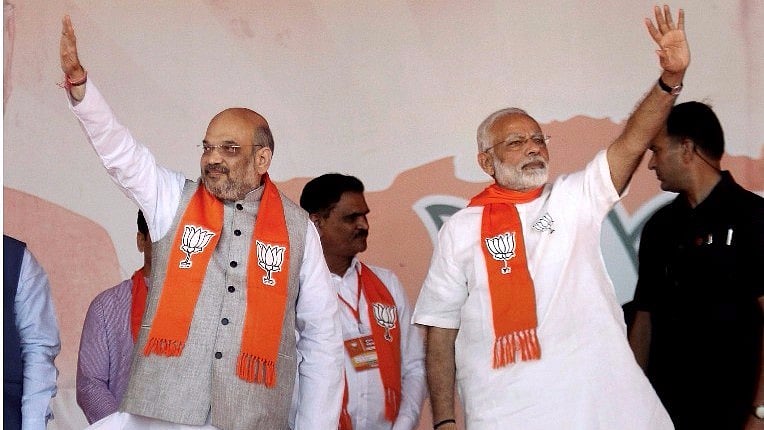 Prime Minister Narendra Modi with BJP President Amit Shah waves at crowd during “Gujarat Gaurav Mahasammelan” in Ahmedabad. 