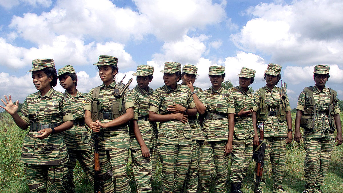 Women fighters of the Liberation Tigers of Tamil Eelam (LTTE) stand on the rebel side of a border crossing in Omanthai in north-central Sri Lanka on 15 February 2002. 