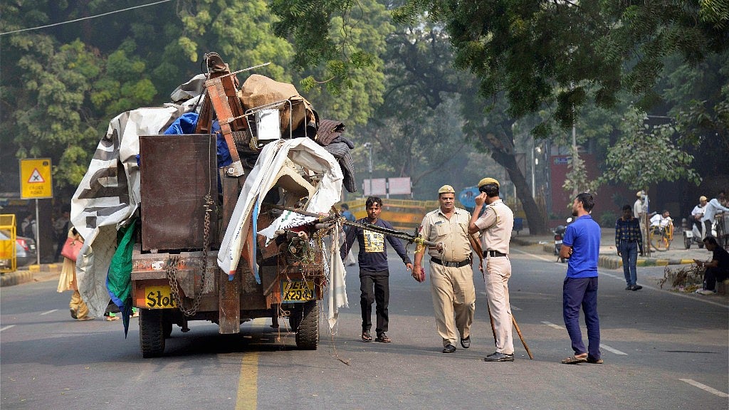 Police monitor as a truck is loaded with materials after evacuation following an NGT order to free Jantar Mantar off protestors, in New Delhi on Monday morning. 