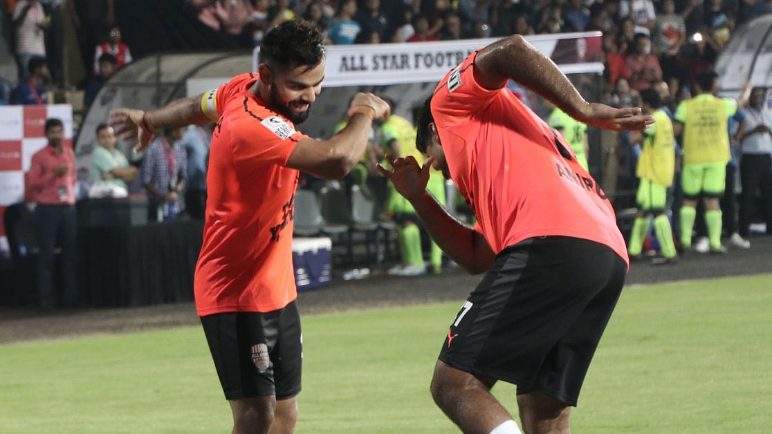 Virat Kohli (L) and Anirudha Srikkanth (R) perform the dab dance during the Celebrity Classico match.
