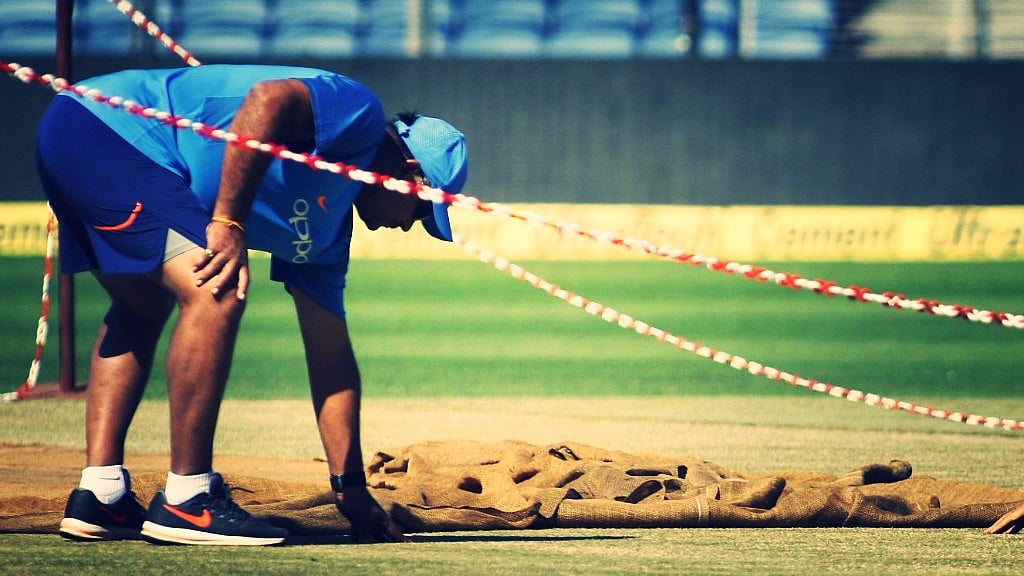 Pune: Indian bowling coach Bharat Arun inspects the pitch during a practice session in Pune on Oct 24, 2017. 