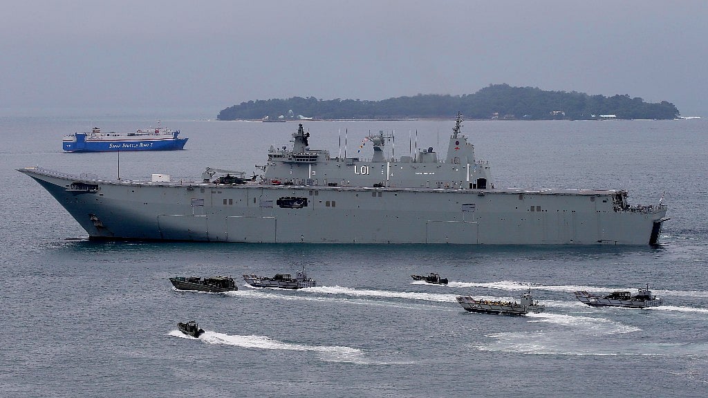 The Royal Australian Navy HMAS Adelaide cruises alongside landing crafts with Philippine Marines and Australian troops as they conduct a joint Humanitarian Aid and Disaster Relief (HADR) exercise off Subic Bay in northwestern Philippines.