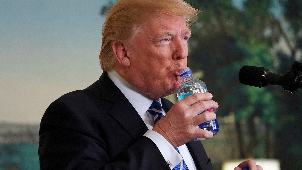 Trump with the Fiji water bottle.