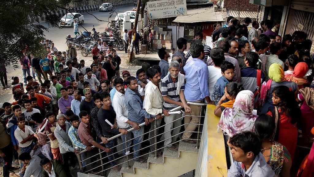 People stand in a queue to deposit and exchange discontinued currency notes outside a bank on the outskirts of New Delhi. Image used for representational purposes. 
