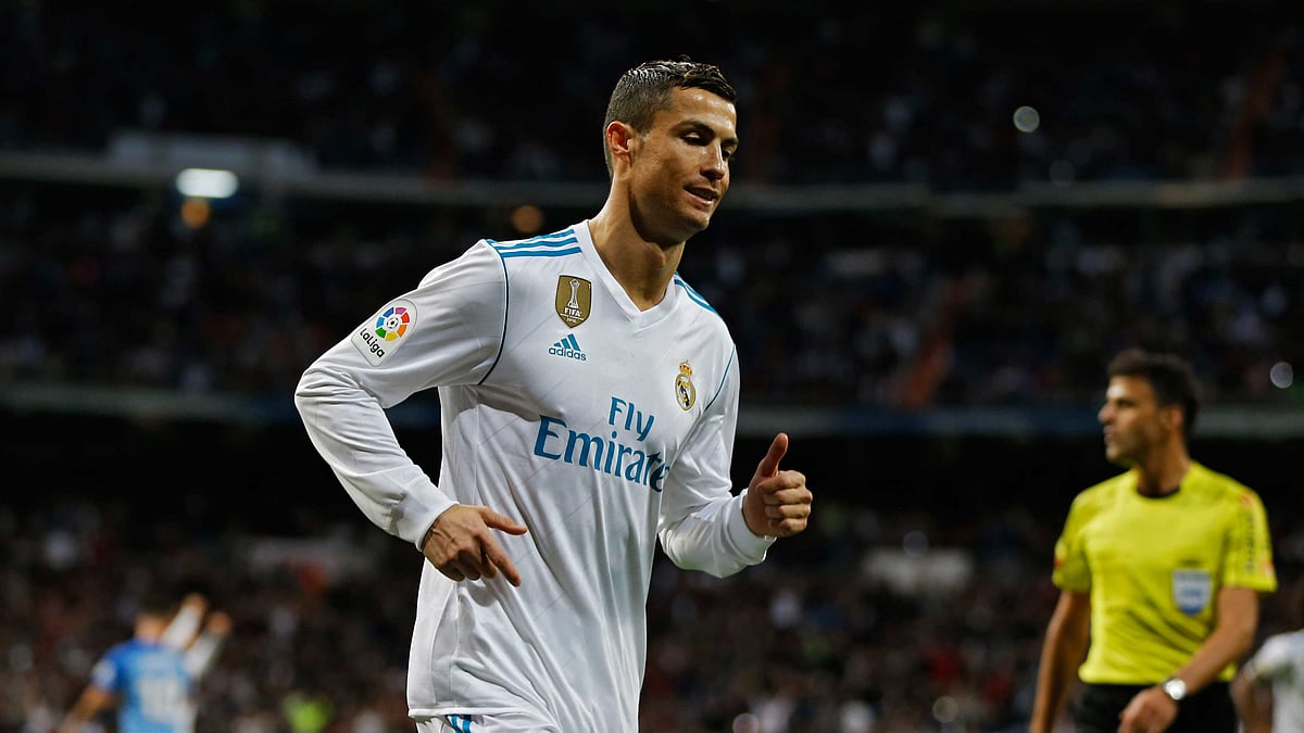 Real Madrid’s Cristiano Ronaldo runs after scoring his side’s third goal against Malaga during the Spanish La Liga soccer match between Real Madrid and Malaga at the Santiago Bernabeu stadium in Madrid, Saturday