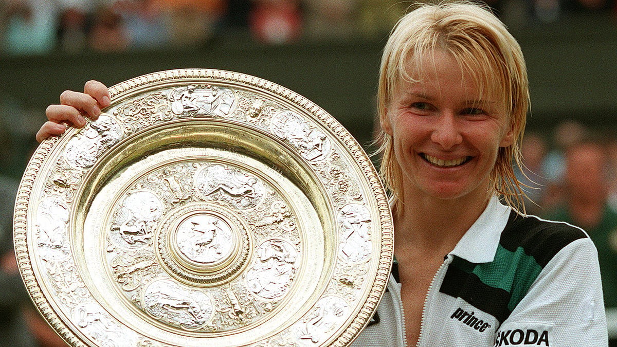  In this July 4, 1998 file photo, Jana Novotna, of the Czech Republic, displays the women’s singles trophy after her victory over France’s Nathalie Tauziat in the final on Wimbledon’s Centre Court.