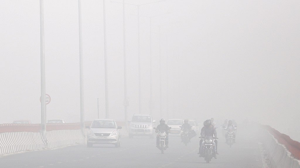 Motorists drive surrounded by smog in New Delhi on 8 November 2017.