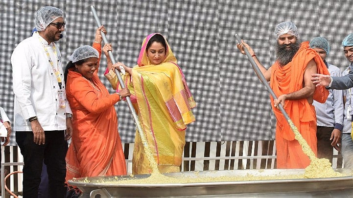 Union Minister of Food Processing Harsimrat Kaur, Badal Sanjeev Kapoor and Ramdev cooking khichdi.