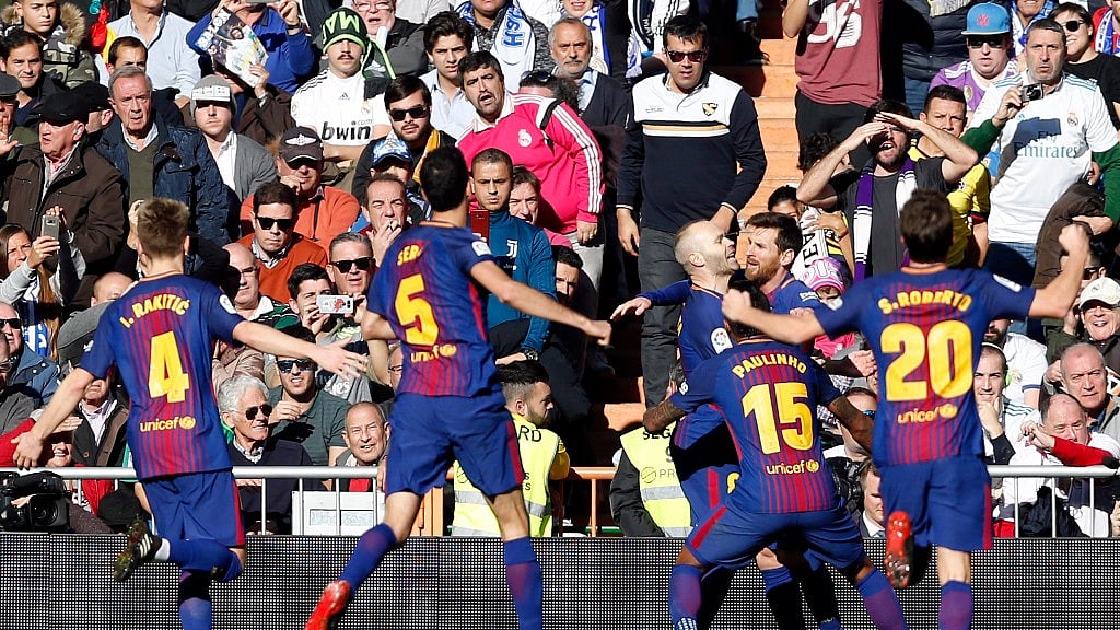 Barcelona’s Lionel Messi, 2nd right, celebrates after scoring his side’s second goal during the Spanish La Liga soccer match between Real Madrid and Barcelona at the Santiago Bernabeu stadium in Madrid, Spain.