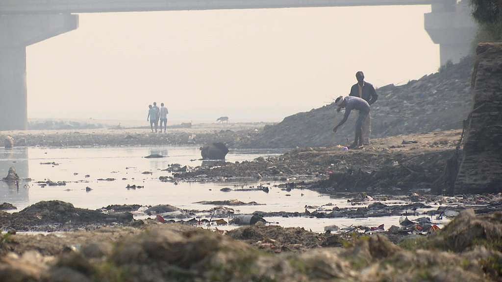 Workers working at the bank of river Ganga near Jajmau.