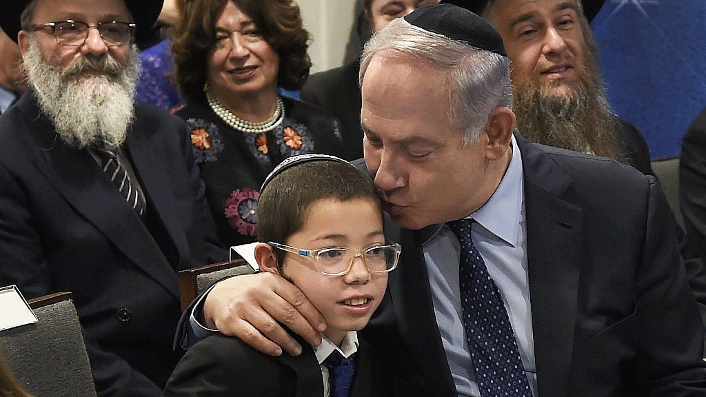 Israeli Prime Minister Benjamin Netanyahu with Moshe Holtzberg and his grandparents after unveiling the Living Memorial in commemoration of the victims of the 26/11 attacks, at Nariman House in Mumbai on 18 January.