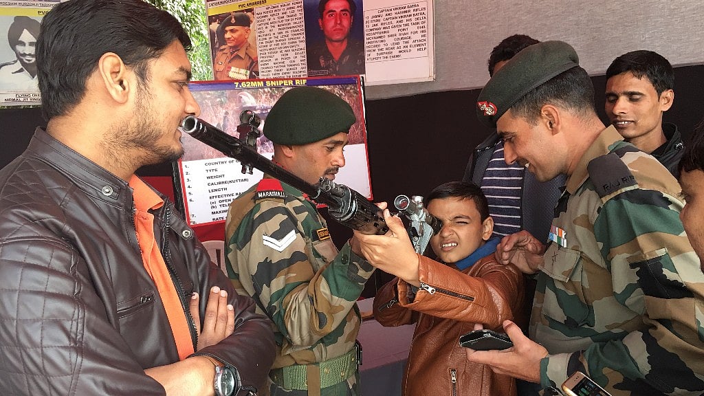 A kid posing with a rifle on display at the Indian Pride Festival at Delhi’s DLF Place mall.