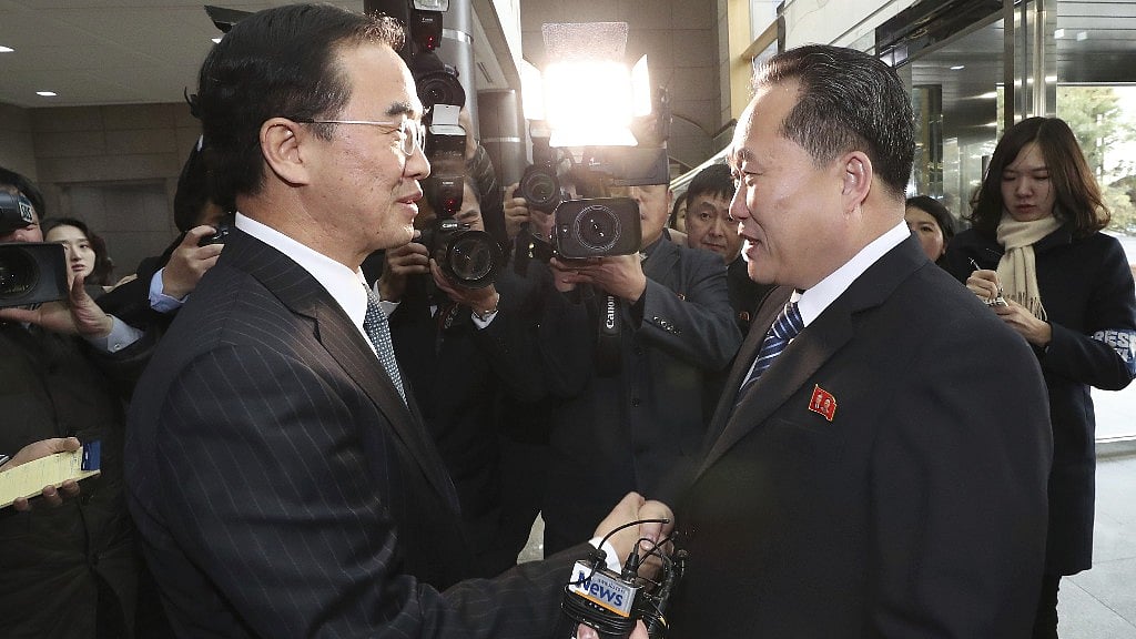 South Korean Unification Minister Cho Myoung-gyon (L), shakes hands with the head of North Korean delegation Ri Son Gwon before their meeting at the Panmunjom, on 9 January.