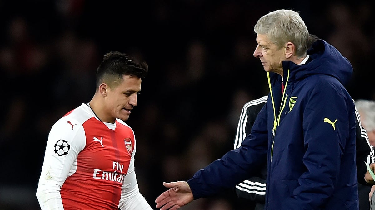 Arsenal’s Alexis Sanchez walks past manager Arsene Wenger after he is substituted during a match.
