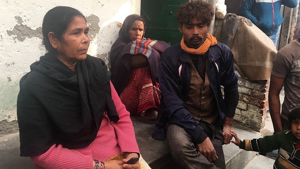 Family members of the deceased grieve the loss of their loved ones in the Bawana factory fire. 