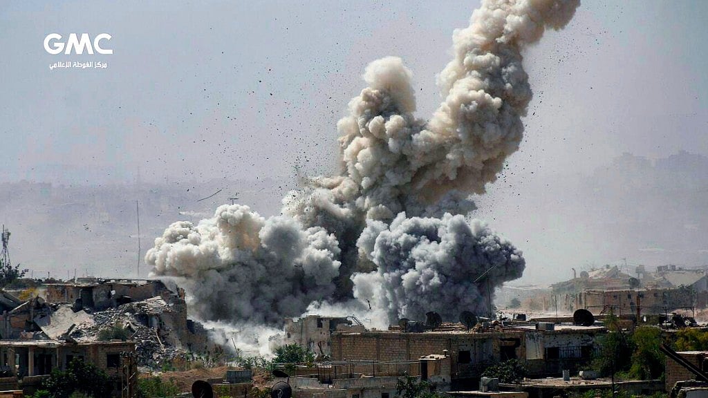 This file photo provided Monday, Sept 25, 2017, by the Ghouta Media Center, a Syrian activist media group, shows smoke and debris rising after Syrian government shelling of the rebel-held Jobar neighborhood of Damascus, Syria.