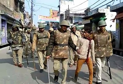 Kasganj: Police detains a protester as an irate mob went on a rampage after two communities clashed in Kasganj district of Uttar Pradesh on Jan 27, 2018. The incident took place when a "Tiranga Yatra" in the form of a bike rally was taken out by ABVP and some other Hindu organisations in the town. As they were passing through the Hulka locality -- a Muslim majority area -- some youths pelted stones on the bikers on Friday. One person was killed and another critically injured in the incident. (Ph