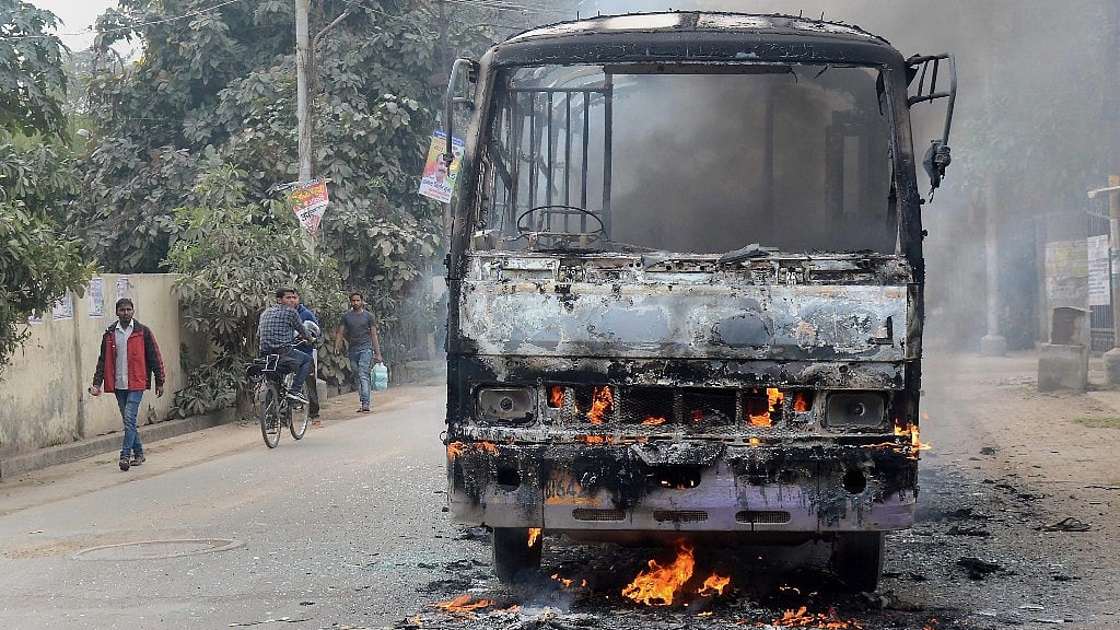 A city bus that was set ablaze by angry students of the Allahabad Central University while protesting the brutal murder of a law student in Allahabad on Monday, 12 February.