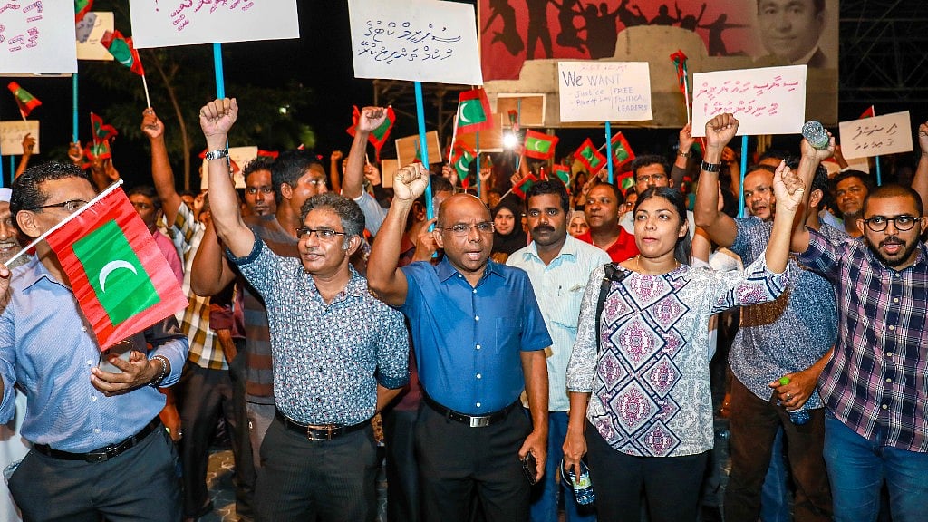 Maldivian opposition supporters shout slogans during a protest as they the urge the government to obey a Supreme Court order to release and retry political prisoners, including an ex-president.