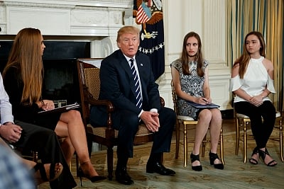 WASHINGTON, Feb. 22, 2018 (Xinhua) -- U.S. President Donald Trump(2nd, L) speaks during a listening session on school safety at the White House in Washington D.C., the United States on Feb 21, 2018. U.S. President Donald Trump promised strong background checks and mental health screenings for gun buyers as he heard pleas from survivors of the recent Florida school shooting and families affected at the White House on Wednesday. (Xinhua/Ting Shen/IANS)