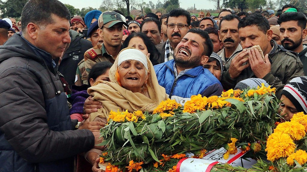 The family of JCO Madan Lal Choudhary, who was martyred in the Sunjwan terror attack, mourn next to his mortal remains. 