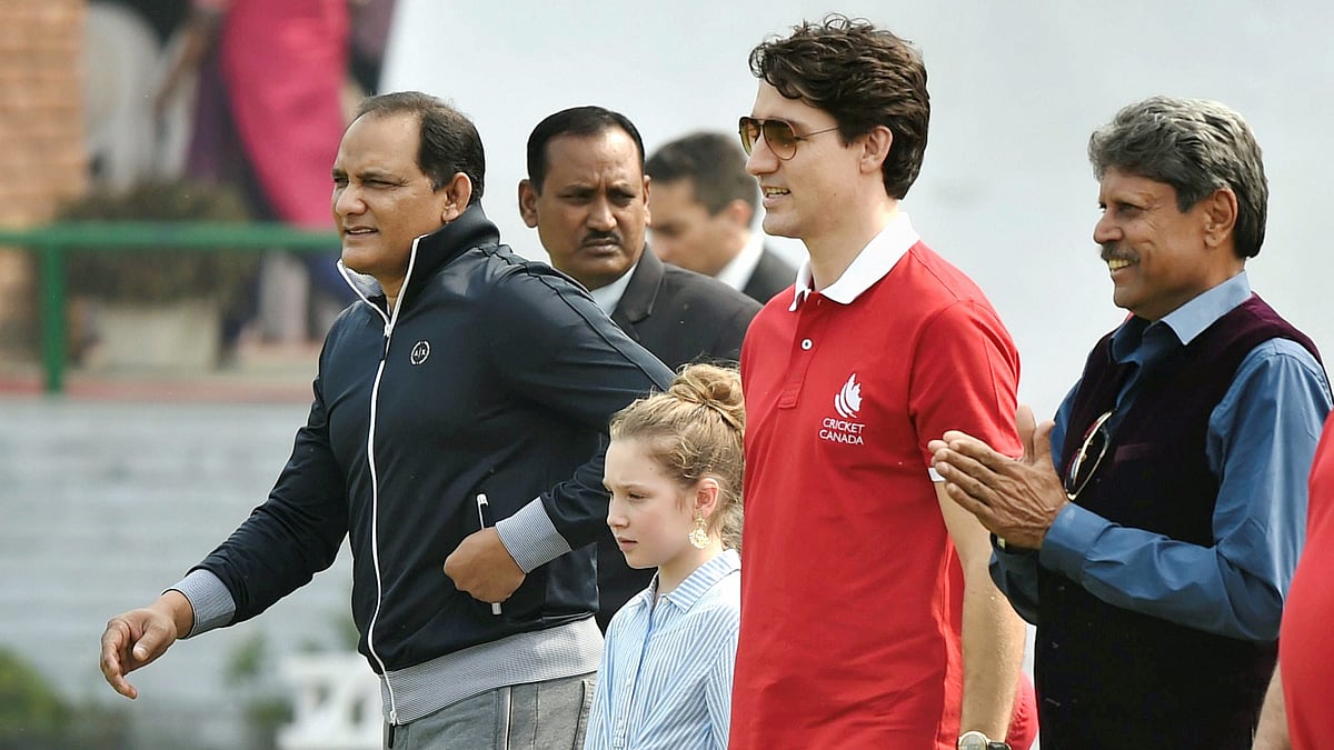 Canadian Prime Minister Justin Trudeau with former India captains Mohammad Azharuddin and Kapil Dev in New Delhi.
