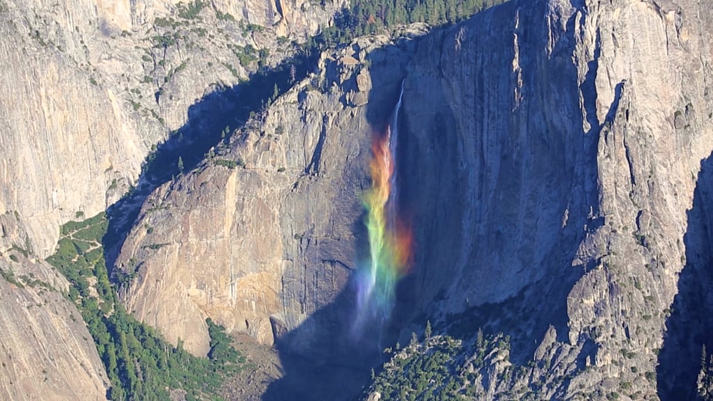 Sunlight falling on Yosemite Falls turns it into a cascading rainbow