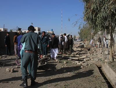 LASHKAR GAH, Feb. 24 (Xinhua) -- Afghan security force members inspect the site of a car bomb attack in Lashkar Gah, capital of Helmand province, Afghanistan, Feb. 24, 2018. At least five people, including two assailants, were killed and 11 others wounded in two separate suicide car bombings in Afghanistan
