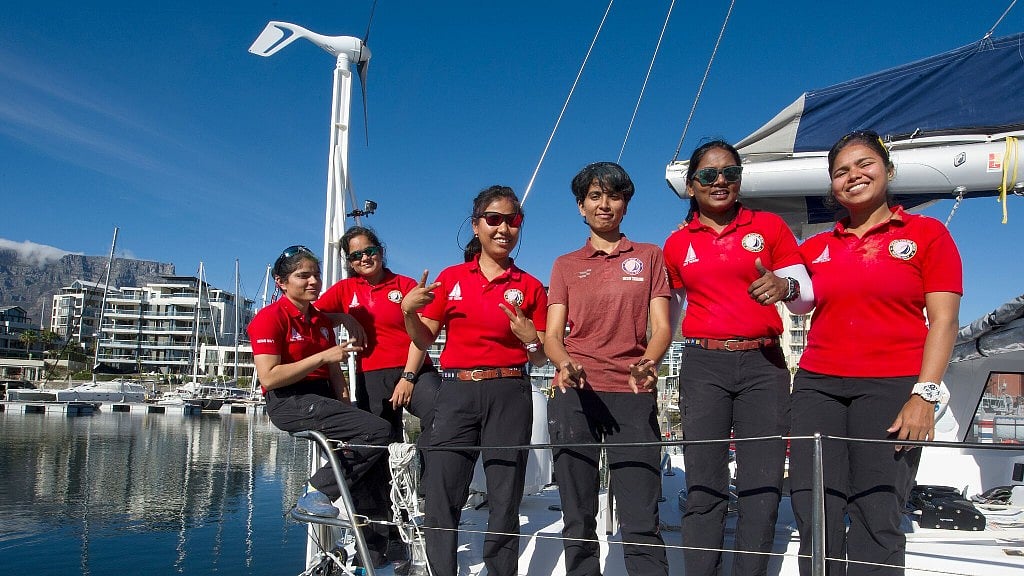 In this photo supplied by Networx PR, crew of the INSV Tarini vessel pose on deck for a photograph after their arrival in Cape Town Harbour, South Africa.
