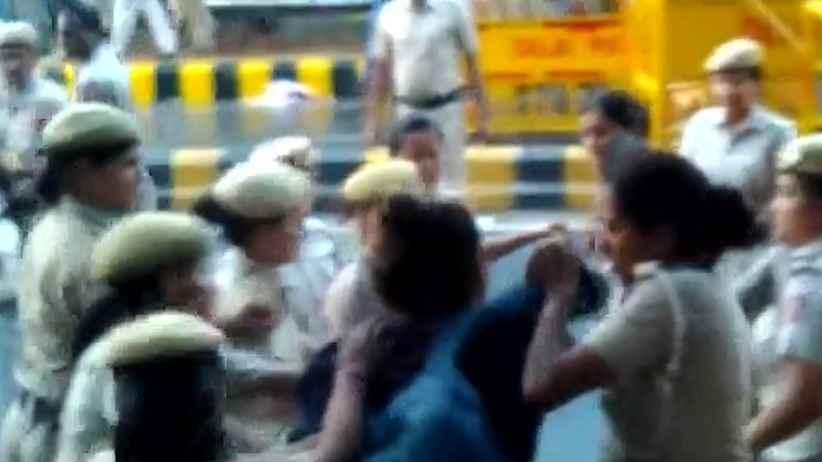Female journalist being manhandled by cops.