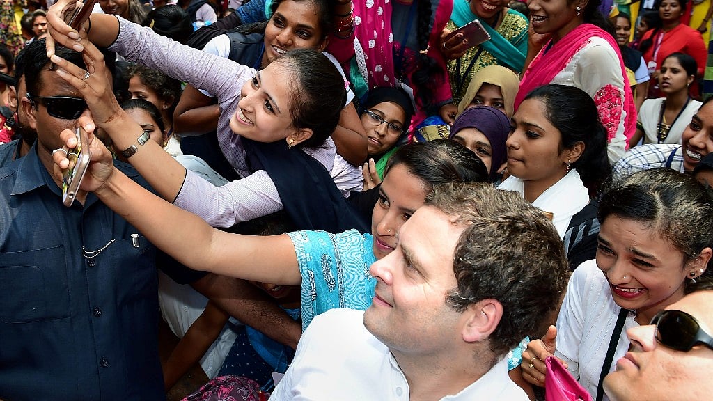 Students of Maharani Arts, Science and Commerce College takes selfie with Congress President Rahul Gandhi, during his Janashirvada Yatra in Mysuru on Saturday.