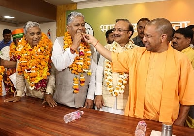 Uttar Pradesh Chief Minister Yogi Adityanath celebrates with newly elected BJP Rajya Sabha members at party office in Lucknow on March 23, 2018. In a nail biting finish, the ruling Bharatiya Janata Party (BJP) managed to get all its nine candidates in the Rajya Sabha polls elected from Uttar Pradesh. The BJP candidates were Union Finance Minister Arun Jaitley, national general secretary Anil Jain, spokesman GVL Narasimha Rao, Vijay Pal Tomar, Kanta Kardam, Ashok Bajpai, Harnath Yadav, Sakaldeep