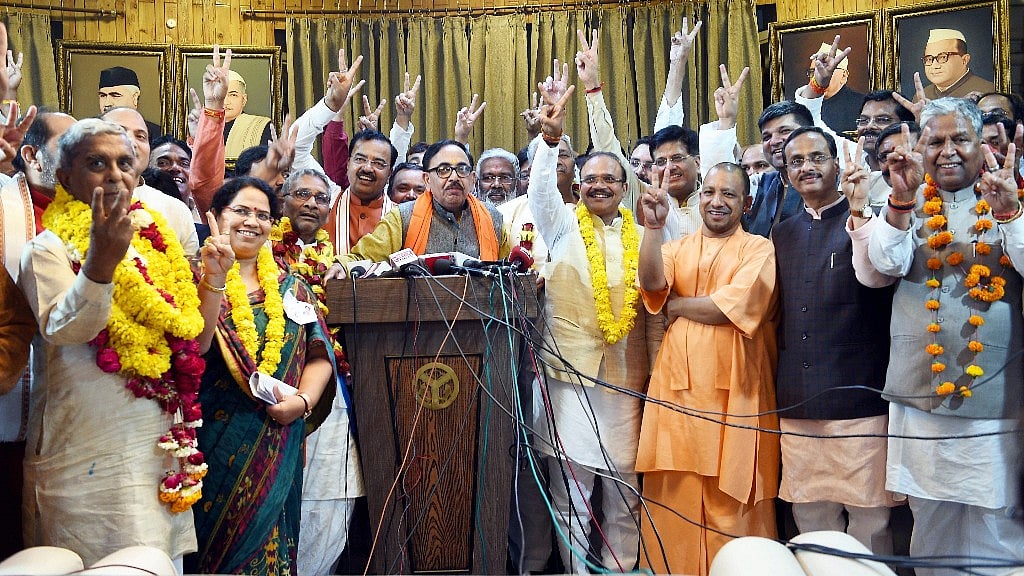 Uttar Pradesh Chief Minister Yogi Adityanath flashes the victory sign with newly elected BJP MPs of Rajya Sabha after BJP wins 9 seats in UP, in Lucknow. 