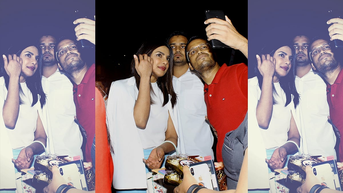 Priyanka Chopra poses for a selfie with a fan.