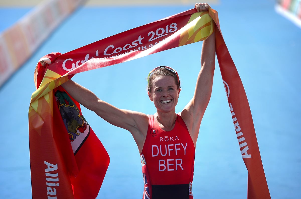 Flora Duffy of Bermuda celebrates as she wins the women’s triathlon.