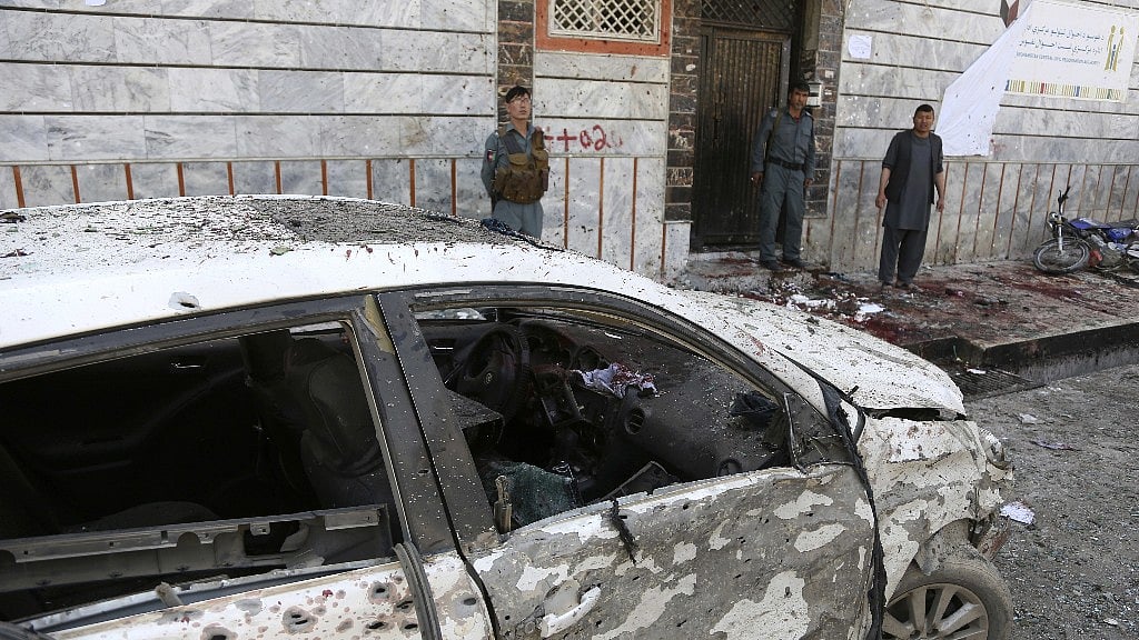 Afghan police stand outside a voter registration center which was attacked by a suicide bomber in Kabul.
